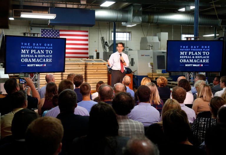 Republican presidential candidate, Wisconsin Gov. Scott Walker, presents his plan to replace Obamacare, during a visit to Cass Screw Machine Products, Tuesday, Aug. 18, 2015, in Brooklyn Center, Minn. (AP Photo/Jim Mone)
