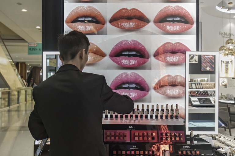 An employee arranges cosmetics at an Estee Lauder store in Shanghai. The U.S. company hopes to avoid tariffs that might curb sales.