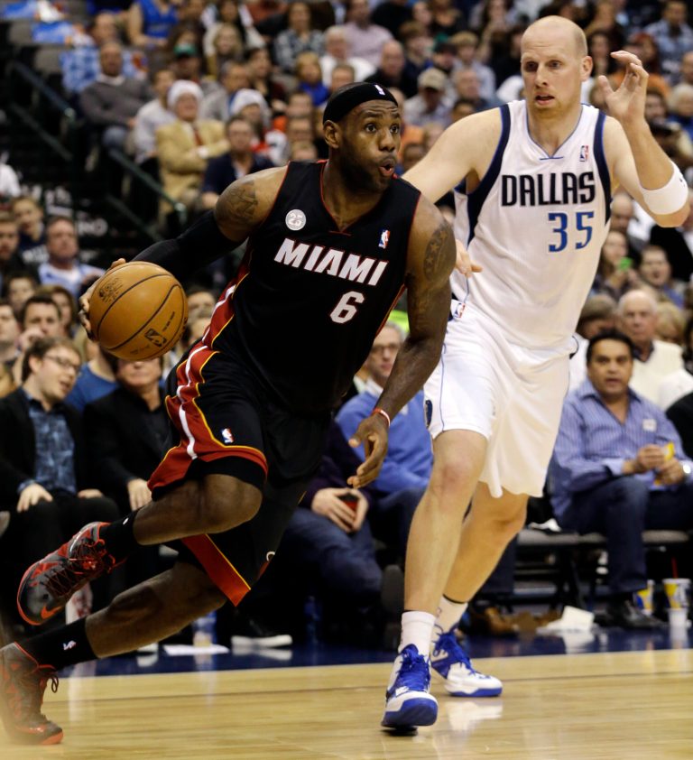   Miami Heat forward LeBron James (6) drives past Dallas Mavericks center Chris Kaman (35) during the first quarter of an NBA basketball game, Thursday, Dec. 20, 2012, Dallas. (AP Photo/LM Otero)  