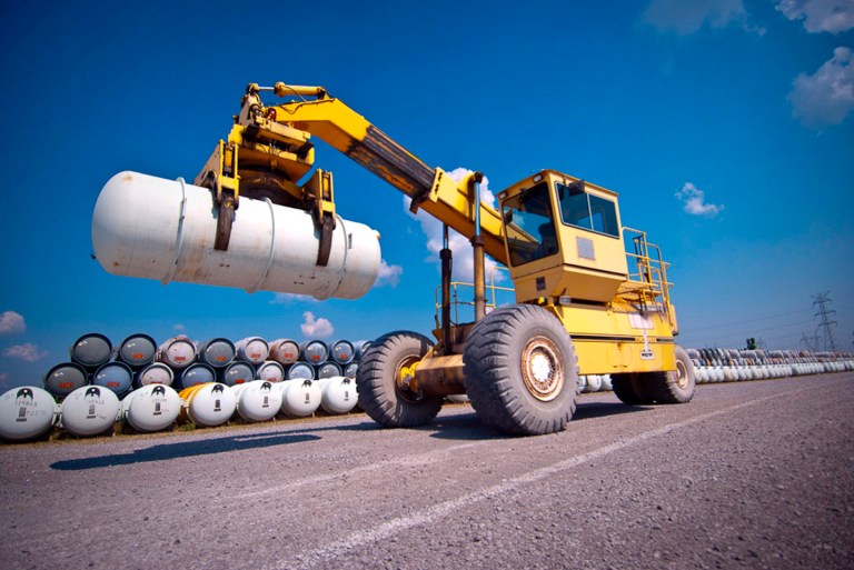 This undated photo provided by United States Enrichment Corp shows Ronnie Kineman, a member of USEC's cylinder handling crew, moving a Department of Energy-owned depleted uranium 