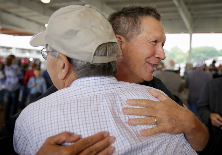Republican presidential candidate, Ohio Gov. John Kasich gets a hug from Iowa Gov. Terry Branstad, left, during a visit to the Iowa State Fair, Tuesday, Aug. 18, 2015, in Des Moines, Iowa. (AP Photo/Charlie Neibergall)