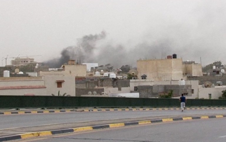 In this image made from video provided by the Libyan national army via AP Television, smoke rises over the parliament area after troops of Gen. Khalifa Hifter targeted Islamist lawmakers and officials at the parliament in Tripoli, Libya, Sunday, May 18, 2014. Forces loyal to a rogue Libyan general attacked the country's parliament Sunday, expanding his eastern offensive against Islamists into the heart of the country's capital. (AP Photo/Libyan national army)