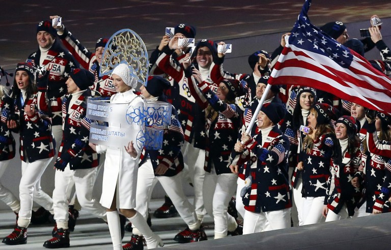 FILE - In this Friday, Feb. 7, 2014 file photo, members of the United States Olympic team _ many of them holding up mobile phones to record the moment _ enter Fisht Stadium in Sochi, Russia, for the opening ceremony of the 2014 Winter Olympics. Picking up new followers on Twitter, Facebook and other social media platforms is the smart play for Olympians at the Sochi Games. Athletes who share their experiences from their privileged backstage access at the games could come home from Russia with far stronger hands to woo and squeeze more money from sponsors. (AP Photo/Petr David Josek, File)