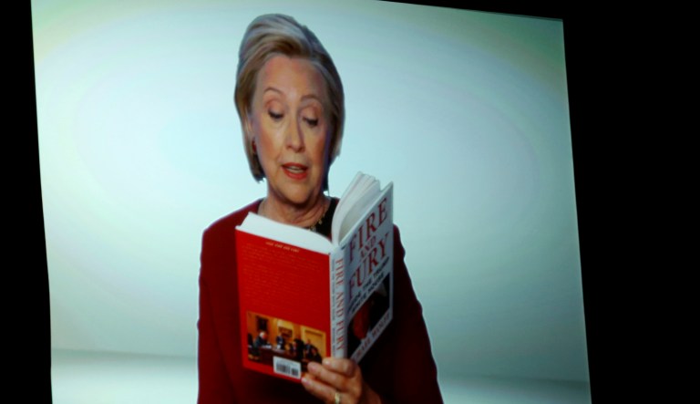 Hillary Clinton appears on screen reading an excerpt from the book 