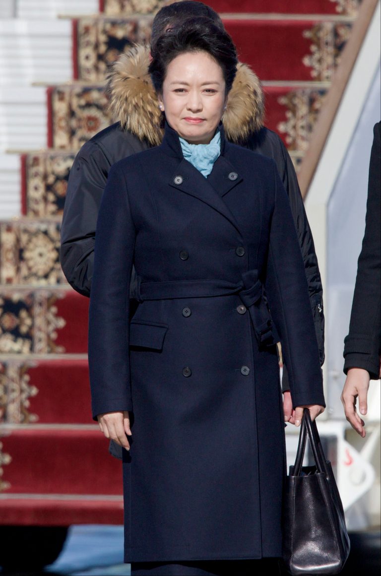 FILE - In this March 22, 2013 file photo, Chinese President Xi Jinping's wife Peng Liyuan smiles after arriving at the government airport Vnukovo II, outside Moscow. China's elegant new first lady's choice of attire has sparked a flurry of excitement over an independent homegrown label, an unusual phenomenon in a country where political figures are more fuddy-duddy than fashionable and wives usually shy away from the spotlight. (AP Photo/Ivan Sekretarev, File)