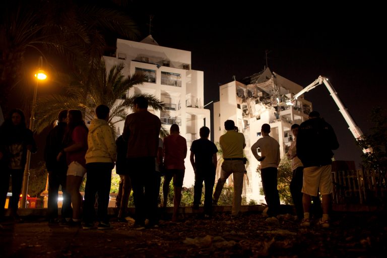   FILE - in this Tuesday, Nov. 20, 2012 file photo, Israelis inspect damage at an apartment building after it was hit by a rocket fired by militants from Gaza Strip, in the israeli central city of Rishon Lezion, near Tel Aviv. Peacemaking with the Palestinians, once the main issue by far in Israeli politics, has been strikingly absent from the campaign for next month's general election. After years of public frustration with failed peace efforts, Prime Minister Benjamin Netanyahu's badly divided challengers are trying instead to tap the economic frustrations of the middle class and a widespread resentment of perks enjoyed by fervently devout Jews. (AP Photo/Oded Balilty, File)  