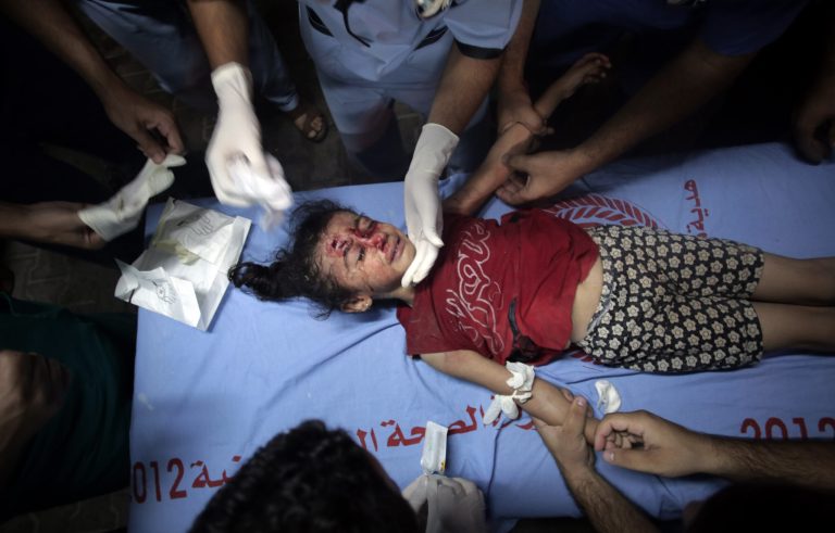 Palestinian medics treat a wounded girl, at the Kuwaiti hospital at Rafah refugee camp, in southern Gaza Strip, Monday, Aug. 4, 2014.  Israel withdrew most of its ground troops from the Gaza Strip on Sunday in an apparent winding down of the nearly monthlong operation against Hamas that has left more than 1,800 Palestinians and more than 60 Israelis dead. (AP Photo/Khalil Hamra)