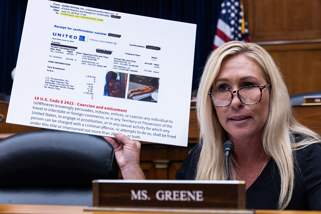 Rep. Marjorie Taylor Greene (R-GA) holds up a sign of a photo depicting a woman in a bathing suit, as well as a plane ticket that Hunter Biden allegedly purchased, during an impeachment inquiry hearing of President Joe Biden on Thursday. During the hearing, Greene said, “It is sad that my Democratic colleagues pretend to care about women’s rights while allowing Hunter Biden to exploit women.” Greene came under fire in July for showing naked images of Hunter Biden during a hearing.