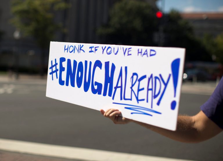 A furloughed federal worker, who did not wish to be identified, holds out a sign to passing traffic on Pennsylvania Avenue in Washington, Wednesday, Oct. 2, 2013. President Barack Obama summoned congressional leaders to the White House on the second day of a partial government shutdown that has furloughed hundreds of thousands of workers and closed military cemeteries as far away as France. Republican leaders welcomed the Wednesday afternoon meeting but questioned whether Democrats were ready to deal. (AP Photo/Carolyn Kaster)