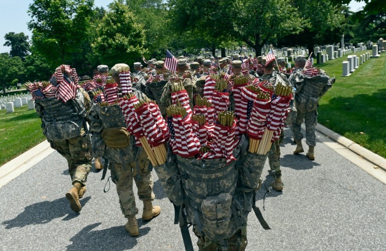 The Old Guard, the Army's official ceremonial unit, placed flags on more than 228,000 headstones and 7,000 niche rows at Arlington National Cemetery. (AP Photo)