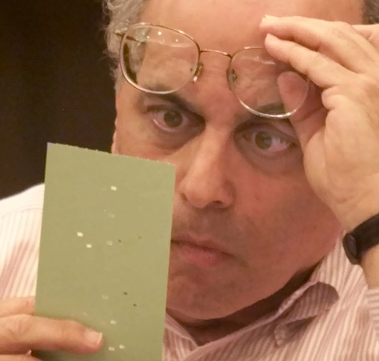 Broward County canvassing board member Judge Robert Rosenberg examines a disputed absentee ballot Saturday, Nov. 25, 2000, at the Broward County Courthouse in Fort Lauderdale, Fla. (AP Photo/Wilfredo Lee)
