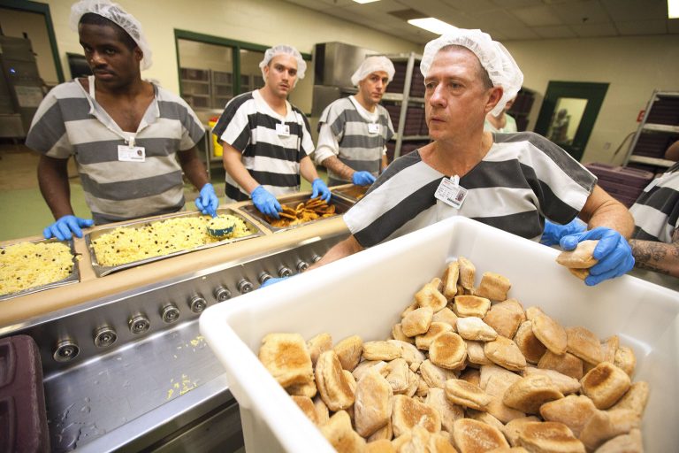Inmate Gerald Lewis, front, and other inmates serve up lunch at the Marion County Jail in Ocala, Fla., Jan. 6, 2014. Inmates at the jail are served three meals a day. In 2012 and 2013, the average inmate population on any given day was 1,546. That means roughly 4,638 food trays a day, or 1,692,870 meals per year. (AP Photo/Ocala Star-Banner, Alan Youngblood) MAGS OUT