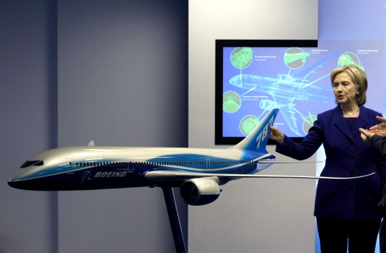Former U.S. Secretary of State Hillary Clinton looks at a model of new Boeing aircraft while visiting the Boeing design center in Moscow, Russia, Oct. 13, 2009. (AP Photo/Misha Japaridze)