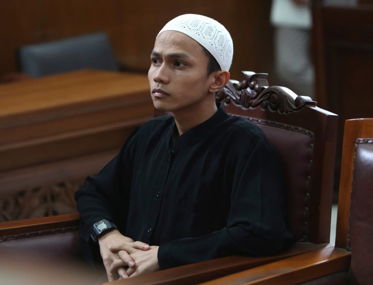 Islamist militant Sigit Indrajit listens to the judges during his hearing at a district court in Jakarta, Indonesia, Tuesday, Jan. 21, 2014.  The Indonesian court sentenced Indrajit to seven and half years in prison for masterminding a plot to attack the Myanmar Embassy in the Indonesian capital. (AP Photo/Tatan Syuflana)
