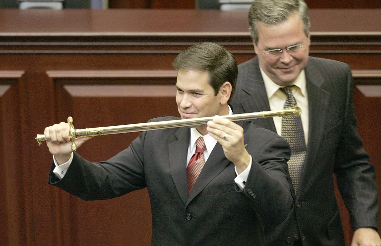 Rep. Marco Rubio, R-Miami, left, holds a sword presented to him by Gov. Jeb Bush, right, during ceremonies designating Rubio as the next Speaker of the House, Tuesday, Sept. 13, 2005, in Tallahassee, Fla. (AP Photo/Phil Coale)