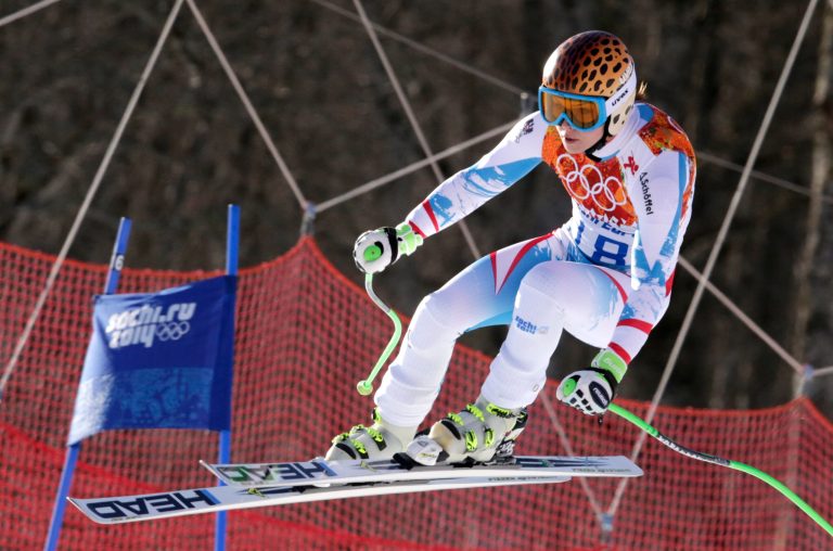 Austria's Anna Fenninger makes a jump in the women's super-G at the Sochi 2014 Winter Olympics, Saturday, Feb. 15, 2014, in Krasnaya Polyana, Russia. (AP Photo/Charles Krupa)