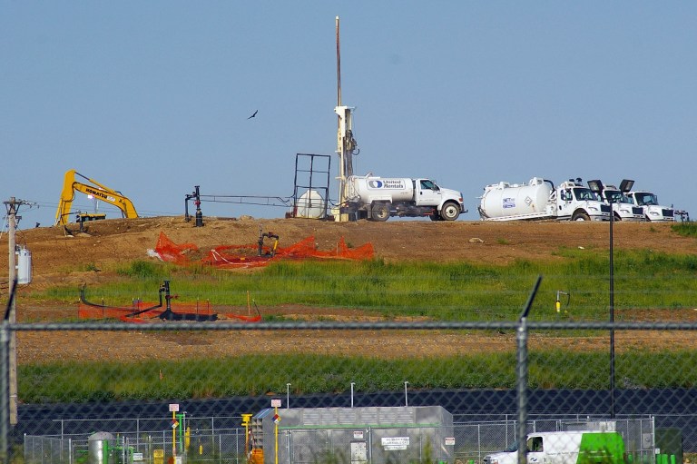 FILE - In this May 22, 2013, file photo workers try to reduce odors caused by an  underground fire at the Bridgeton Landfill in Bridgeton, Mo. Missouri Attorney General Chris Koster's office and the owners of the landfill reached an agreement Thursday, June 19, 2014 on measures aimed at better controlling underground smoldering and reducing a strong odor that for months has troubled residents in a densely populated area of suburban St. Louis. (AP Photo/St. Louis Post-Dispatch, Roland Klose, File)