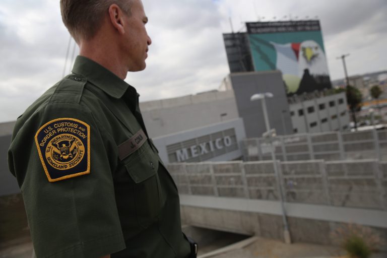 U.S. Border Patrol agent Jerry Conlin stands on the American side of the U.S.-Mexico border on October 3, 2013 at the San Ysidro port of enty into Mexico, California. (Photo by John Moore/Getty Images)