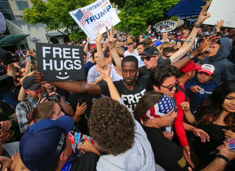 Fights break out between protestors and Trump backers, causing police to step in. (Howard Lipin/The San Diego Union-Tribune via AP)