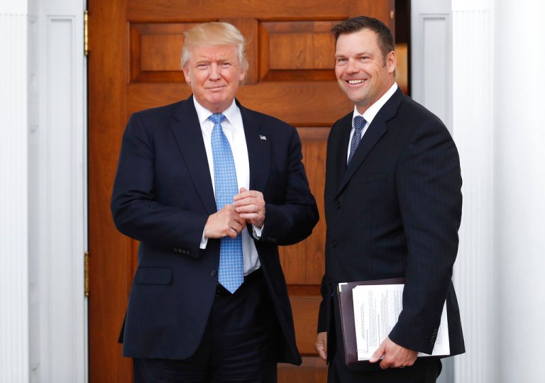FILE - In this Nov. 20, 2016, file photo, Kansas Secretary of State Kris Kobach, right, holds a stack of papers as he meets with then President-elect Donald Trump at the Trump National Golf Club Bedminster clubhouse in Bedminster, N.J. Civil rights advocates say Kobach is trying to hide materials that undercut his public claim that substantial numbers of noncitizens have registered to vote. The American Civil Liberties Union obtained the documents as part of its federal civil lawsuit in Kansas challenging the state's proof-of-citizenship document requirement. It wants to court to remove the confidential designation Kobach placed on materials he was photographed taking into a November meeting. (AP Photo/Carolyn Kaster, File)