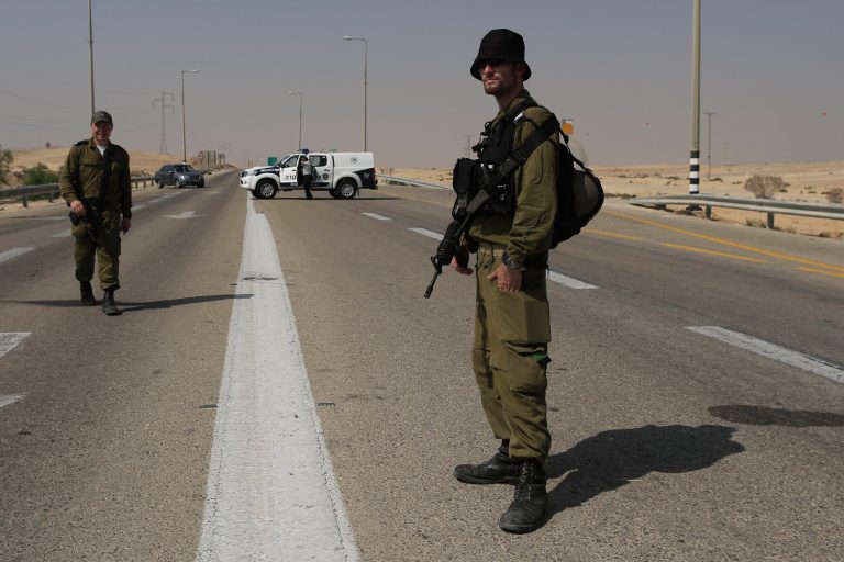   Israeli security forces secure the area after an attack, near the southern Israeli city of Beersheva, Monday, June 18, 2012. Unidentified militants crossed from Egypt's turbulent Sinai Peninsula into southern Israel on Monday, opening light arms and anti-tank fire on civilians building a security fence meant to fortify the porous border, defense officials said. One of the Israeli workers was killed, and two militants were gunned down by troops responding to the attack, the officials said. (AP Photo/Tsafrir Abayov)  