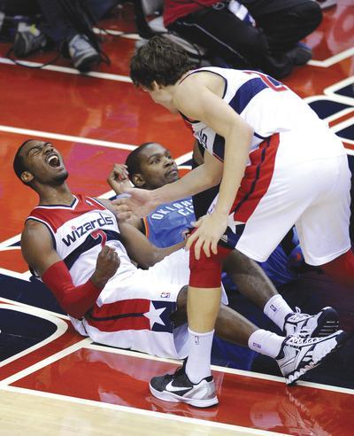 Nick Wass/AP
John Wall finished with 25 points, eight assists and seven rebounds and took a key charge from Kevin Durant in the second half.