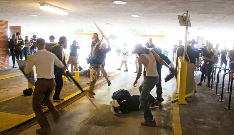 DeAndre Harris is assaulted in a parking garage beside the Charlottesville police station after a white nationalist rally was disbursed by police in Charlottesville, Va. Harris is now facing felony charges, according to a new report. (Zach D. Roberts via AP)