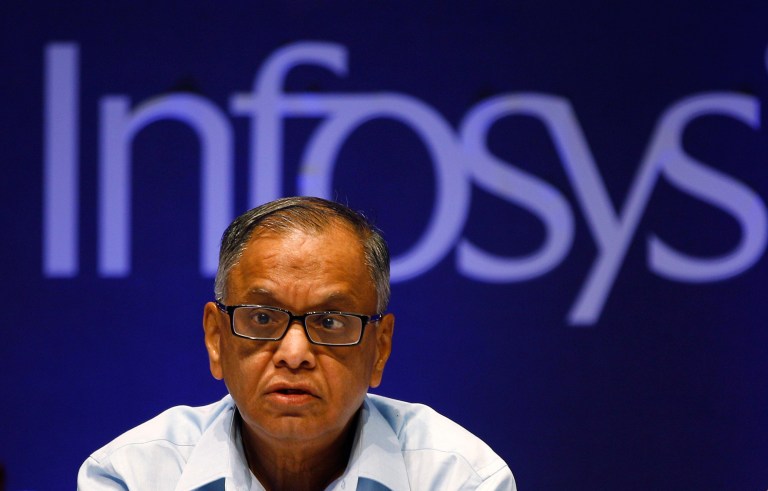 FILE- In this June 15, 2013 file photo, Infosys Executive Chairman N. R. Narayana Murthy reacts to a shareholders comment during the company's 32th Annual General Meeting in Bangalore, India.  In 2013 Infosys was accused of bringing thousands of foreign workers to the United States using incorrect visas, but denied any allegations as part of the settlement reached with a $34 million settlement in Texas. (AP Photo/Aijaz Rahi)