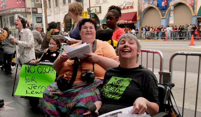 Carrie Ann Lucas, center, who opposes the Colorado measure and has a neuromuscular disease that requires her to use a ventilator, said that someone like her would qualify for Colorado's life-ending prescription. (AP Photo/Nick Ut)