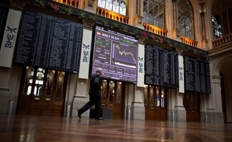   A man walks pass to the main display at the Stock Exchange in Madrid, Spain, Monday, June 4, 2012. The Labor Ministry reported today a drop of 30,313 people claiming benefits, to a total of 4,71 million unemployed people in May, a traditionally good month for hiring as companies prepare for the vacation season. (AP Photo/Alberto Di Lolli)  