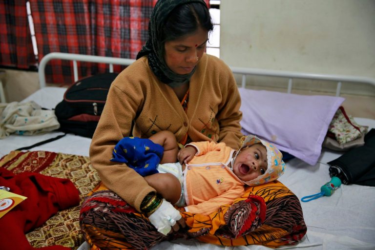 Landslide survivor Pramila Lende holds her son Rudra who was injured in the same landslide, at a hospital in Manchar, in the western Indian state of Maharashtra, India, Friday, Aug. 1, 2014. One of the few people pulled alive from the rubble in the hours after the landslide were Lende and her 3-month-old son. Lende said she was feeding her son when she heard the roar of earth and mud ripping down the hillside. Rescuers searching for dozens of people still missing after the landslide. Chances of finding anyone alive were increasingly slim. (AP Photo/Rafiq Maqbool)