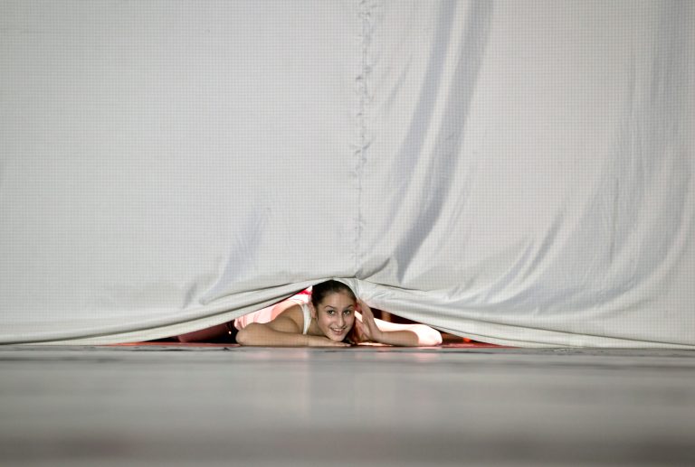 A girl peers from under a curtain before the start of a performance coordinated by US Battery Dance Company to mark World Down Syndrome Day in Bucharest, Romania, Thursday, March 2013. The U.S. company helped create dance performances for groups of children with disabilities, young ethnic Roma children and youngsters who aspire to become dancers. (AP Photo/Vadim Ghirda)