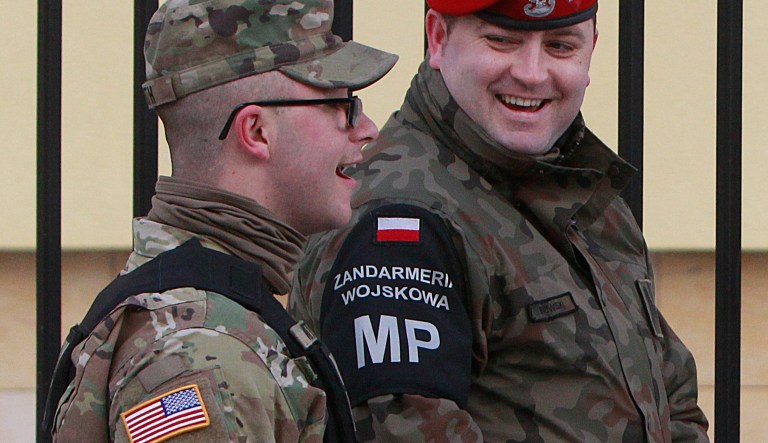 An American and a Polish soldier chat during an official welcome ceremony of the US troops convoy in Zagan, Poland, Thursday, Jan. 12, 2017. U.S. soldiers arrived in Poland in January and fanned out to sites across Eastern Europe, where concerns run highest over Russia's claims on Crimea and its assistance to rebels fighting the Ukraine government. (AP Photo/Czarek Sokolowski)