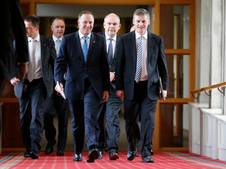 New Zealand's Finance Minister Bill English, right, walks with Prime Minister John Key, center, on their way to reading the Budget 2014 in Parliament, Wellington, Thursday, May 15, 2014. New Zealand will become one of the first developed nations to return to a budget surplus since the 2008 financial crisis plunged the global economy into recession, the government said. (AP Photo/New Zealand Herald, Mark Mitchell) NEW ZEALAND OUT, AUSTRALIA OUT
