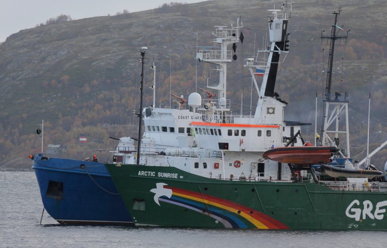 FILE - This is a Tuesday, Sept. 24, 2013.  file photo of  Greenpeace ship 'Arctic Sunrise'  as it is escorted by a Russian coast guard boat, in Kola Bay at the military base Severomorsk on the Kola peninsula in Russia. Greenpeace International says Russian authorities have informed the activist group they will release the ship Arctic Sunrise, which has been held in Murmansk since it was seized during a protest against an offshore oil platform in September 2013. Amsterdam-based Greenpeace said Friday  June 6, 2014 it still believes the actions of Russian authorities in seizing the ship and arresting 30 people on board were against international law.  (AP Photo/Efrem Lukatsky, File)