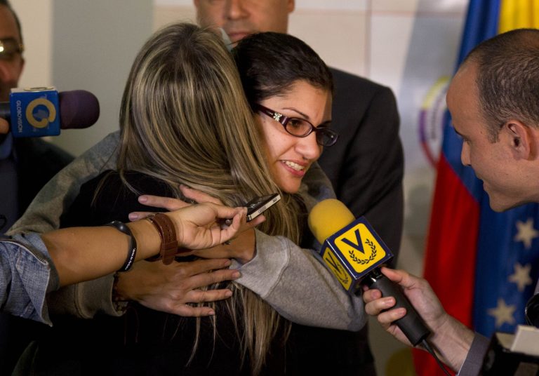 Globovision journalist Nairobi Pinto hugs a colleague as she answers a reporter's question after a press conference following her release from a kidnapping in Caracas, Venezuela, Monday, April 14, 2014. Pinto was freed eight days after she was kidnapped in the town of Cua in Miranda state, but it's not yet clear why she was seized. (AP Photo/Ramon Espinosa)