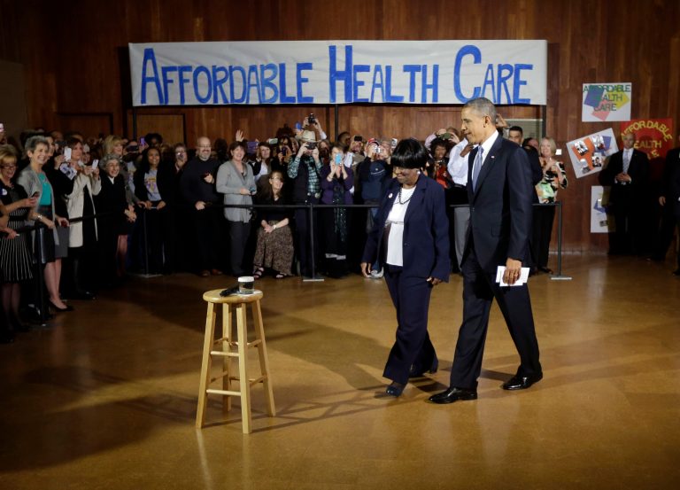 President Barack Obama walks in with volunteer Edna Pemberton before speaking with other volunteers who helped people enroll through the HealthCare.gov site at Temple Emanu-El, a Dallas Area Interfaith, Wednesday, Nov. 6, 2013 in Dallas. Obama traveled to Texas to pitch health care and raise money for the Democratic party. (AP Photo/Pablo Martinez Monsivais)