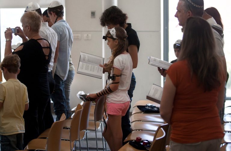   In this Thursday, June 14, 2012 photo an Israeli children pray with their families in a reformist Jewish synagogue, in Mevasseret Zion near Jerusalem. Israel's attorney general recently announced that a group of 15 non-Orthodox rabbis who answer a certain criteria will begin to receive government funding like some 2,000 of their Orthodox and ultra-Orthodox brethren.(AP Photo/Sebastian Scheiner)  