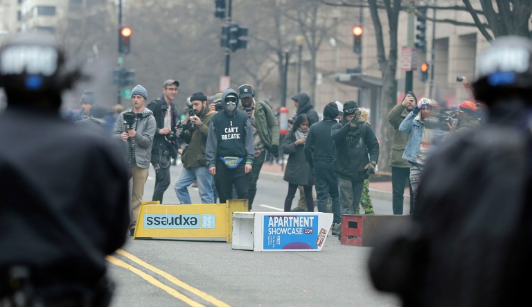 Some reporters and photographers were allowed to walk free before police took more than 230 people to jail on Jan. 20, 2017. Others had charges dropped in the weeks that followed. But journalist Aaron CantÃº's role in a raucous anti-capitalism march remains murky, as does the reason prosecutors excused 129 people from prosecution Thursday, but not CantÃº, keeping his case active alongside just 58 others. (AP Photo/Mark Tenally, File)