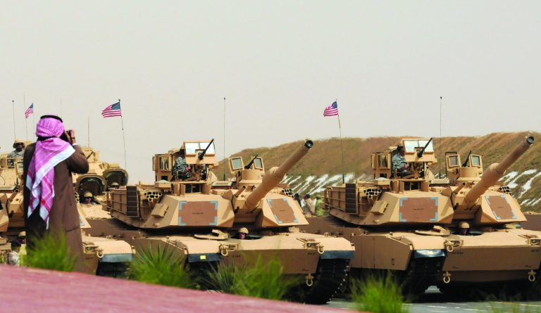 In this Saturday, Feb. 26, 2011, file photo, U.S. Army heavy battle tanks are seen during a military parade commemorating the 20th anniversary of the liberation of Kuwait from the 1990 Iraqi invasion in Subiya, 120km north east of Kuwait City. In the past two months the U.S. Defense Department has notified Congress of possible arms deals totaling more than $11.3 billion to Gulf states such as Qatar and Kuwait, which are seen as among the critical frontline partners in U.S. strategies to counter Iran and protect oil shipping lanes. (AP Photo/Gustavo Ferrari-File)