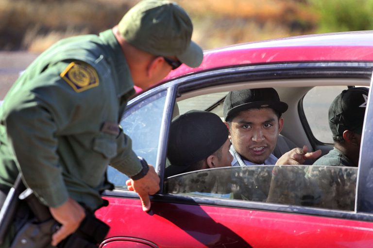 A Border Patrol agent checks vehicles for illegal immigrants and contraband at a roadside checkpoint June 1, 2010 near Sasabe, Ariz. (Photo by Scott Olson/Getty images)