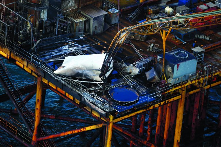 This aerial photograph shows damage from an explosion and fire on an oil rig in the Gulf of Mexico, about 25 miles southeast of Grand Isle, La., Friday, Nov. 16, 2012. Four people were transported to a hospital with critical burns and two were missing. (AP Photo/Gerald Herbert)