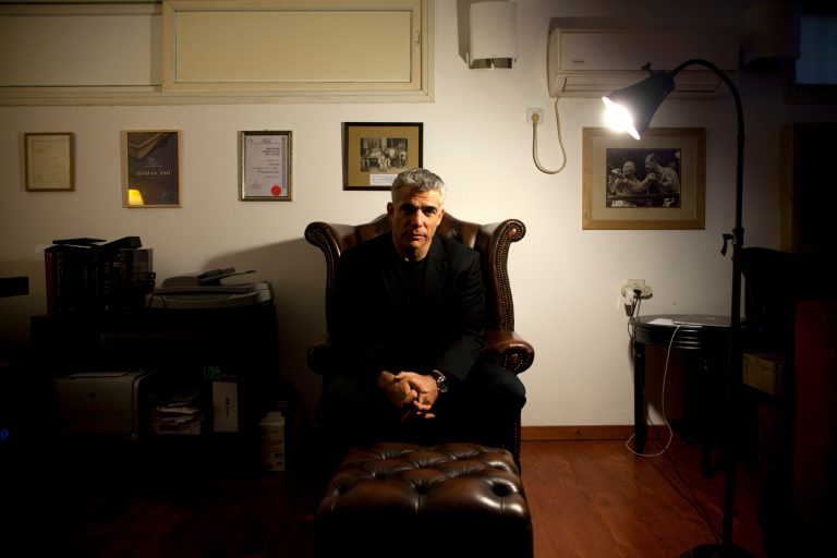File - In this Jan.16, 2013 file photo, Yair Lapid, popular former TV anchorman and head of the new centrist party Yesh Atid, poses for a portrait at his house during an interview for the Associated Press, in Tel Aviv, Israel. Lapid, Prime Minister Benjamin Netanyahu's senior coalition partner, said in a published interview Sunday, May 19, 2013, that reaching a final peace agreement with the Palestinians is unrealistic at the current time and that the sides should instead pursue an interim arrangement. (AP Photo/Oded Balilty, File)