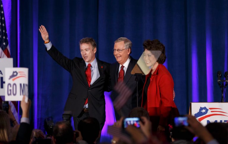 Senate Minority Leader Mitch McConnell of Ky., center, celebrates with Sen. Rand Paul, R-Ky., left, and his wife, former Labor Secretary Elaine Chao, at an election night party in Louisville, Ky.,Tuesday, Nov. 4, 2014. (AP Photo/J. Scott Applewhite)