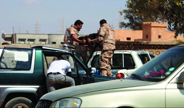 Soldiers from the Libyan National Army get ready to enter Rafallah al-sahati Islamic Militia Brigades compound, the compound buildings can be seen behind the wall, in Benghazi, Libya, Saturday, Sept. 22, 2012. On Friday evening hundreds of protesters angry over last week's killing of the U.S. ambassador to Libya stormed the compound of the Islamic extremist Ansar al-Shariah Brigade militia suspected in the attack, evicting militiamen and setting fire to their building. After taking over the Ansar compound, protesters then drove to attack the Benghazi headquarters of Rafallah Sahati where militiamen opened fire on the protesters, who were largely unarmed leaving at least 20 wounded, and several killed according to hospital sources. (AP Photo/Mohammad Hannon)