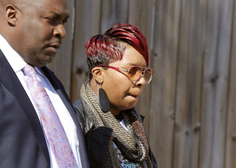 Lesley McSpadden, mother of Michael Brown Jr., departs a news conference with family attorney Daryl Parks Thursday, March 5, 2015, in Dellwood, Mo. (AP Photo/Charles Rex Arbogast)