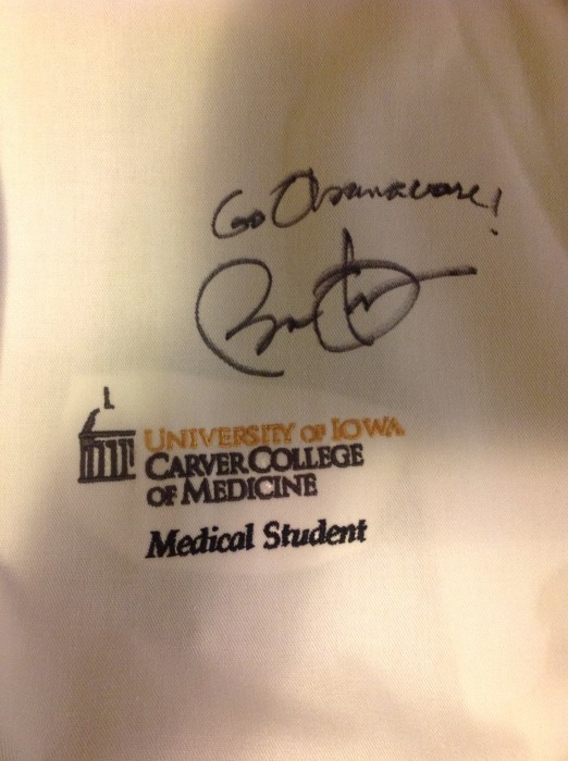 Obama autographs lab coat in Iowa: ‘Go Obamacare!’