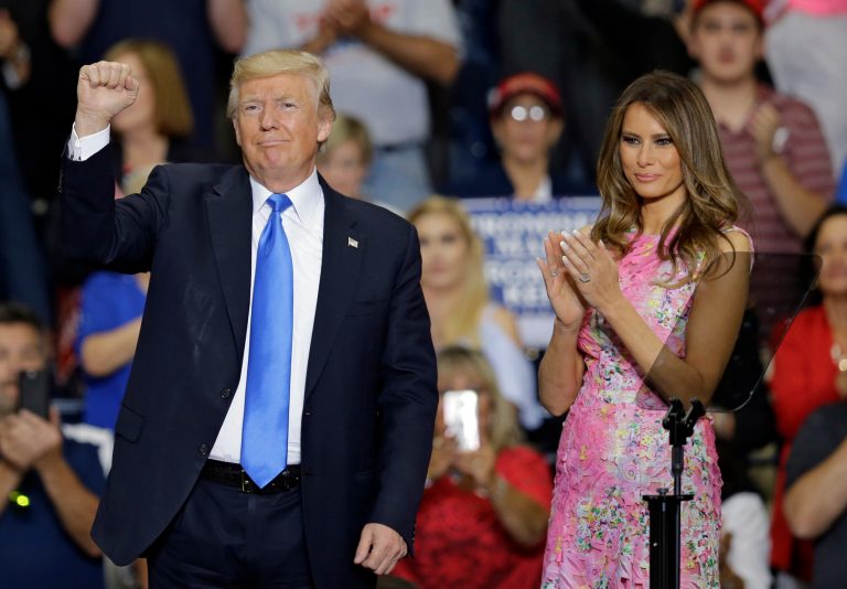 President Donald Trump pumps his fist as first lady Melania Trump watches after he spoke at the Covelli Centre, Tuesday, July 25, 2017, in Youngstown, Ohio. (AP Photo/Tony Dejak)