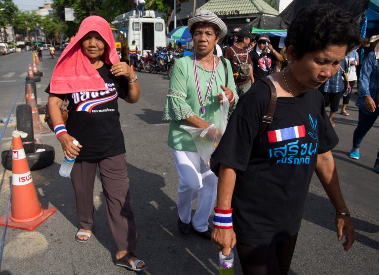 Anti-government protesters walk along cones in Bangkok, Thailand, Wednesday, May 14, 2014. Move a traffic cone placed by people who have spent six months taking over various areas of this politically volatile capital and you could get beaten, stabbed or shot. For many Thais sick of the chaos, it is a chilling thought, but also a chance to meme. Allegations that anti-government protesters have attacked several motorists for moving traffic cones have sparked a mix of outrage and creativity in political cartoons and online postings that went viral this week. (AP Photo/Sakchai Lalit)