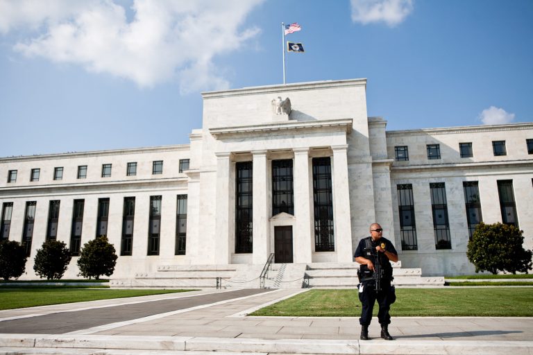 A police officer guards the Federal Reserve building on September 10, 2011, in Washington. (Photo by Brendan Hoffman/Getty Images)